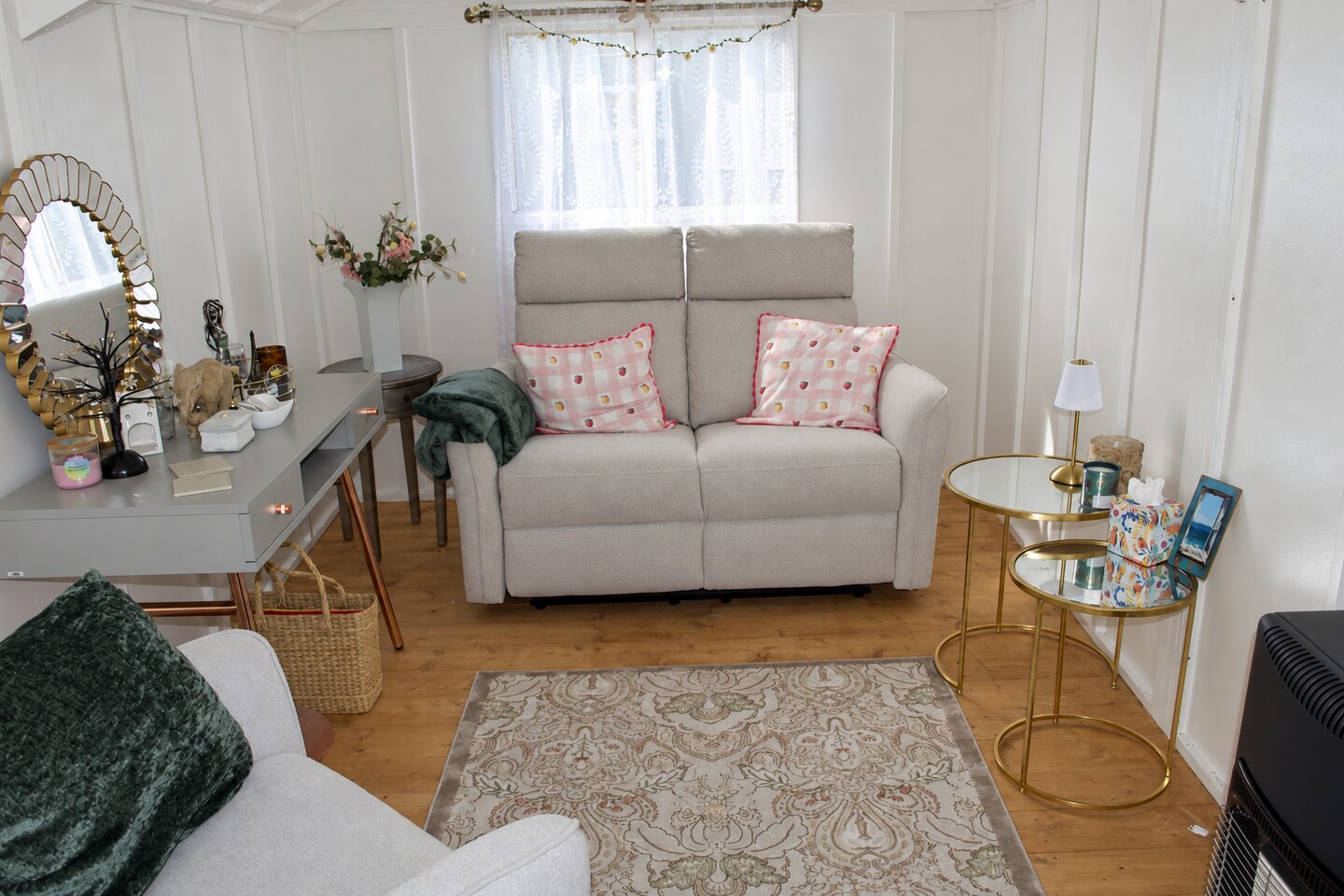 AI-enhanced view of the therapy room, with a grey sofa, armchair, side tables and curtained window